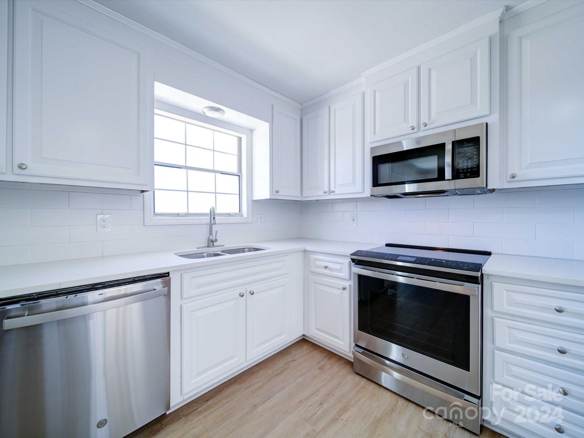 101 Hedgestone Drive Gastonia, NC 28056 - Photo 24 of 39 a kitchen with cabinets stainless steel appliances a sink and a window