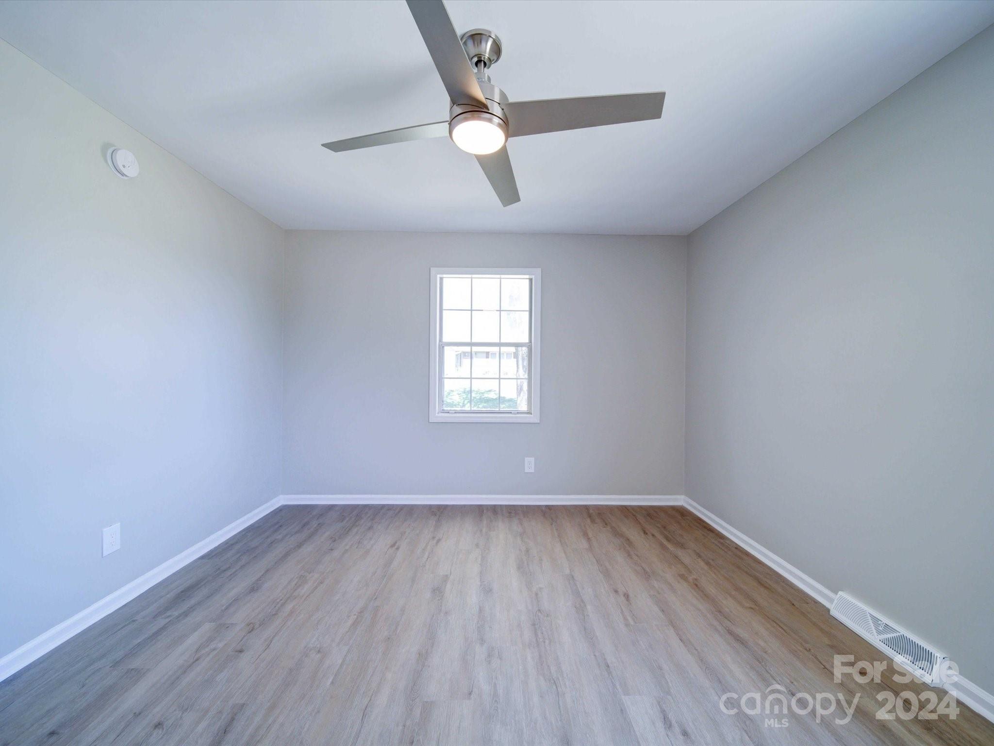 101 Hedgestone Drive Gastonia, NC 28056 - Photo 28 of 39 an empty room with wooden floor and windows