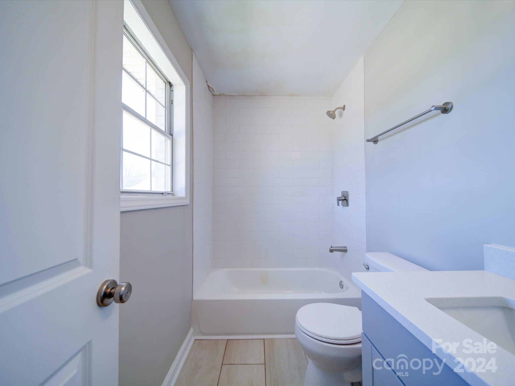 101 Hedgestone Drive Gastonia, NC 28056 - Photo 31 of 39 a bathroom with a granite countertop toilet a sink and a bathtub