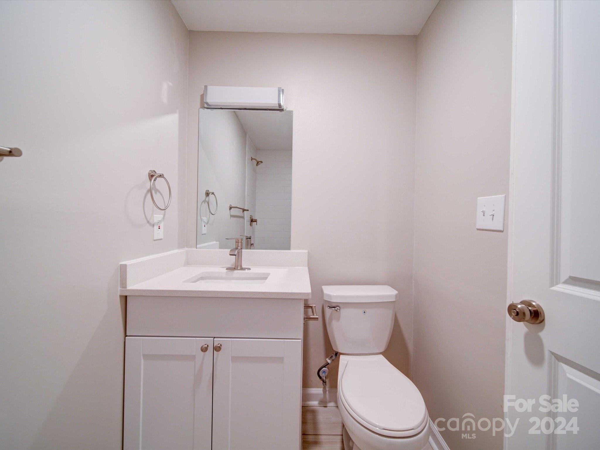 101 Hedgestone Drive Gastonia, NC 28056 - Photo 38 of 39 a bathroom with a toilet a sink and mirror