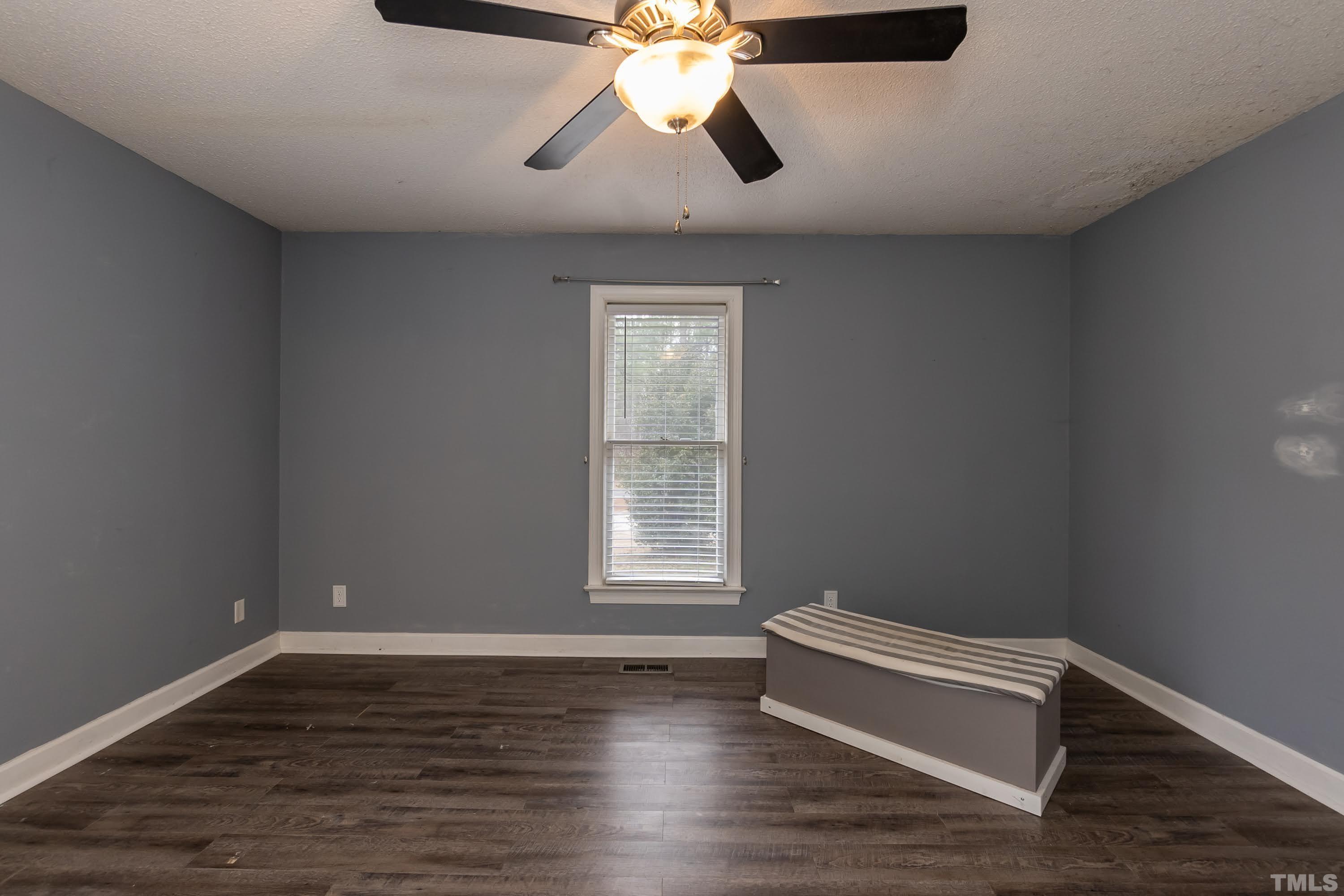 9117 Ferrell Road Zebulon, NC 27597 - Photo 14 of 26 a view of room with window and wooden floor
