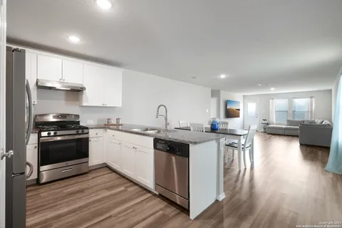 a kitchen with a sink stove and cabinets