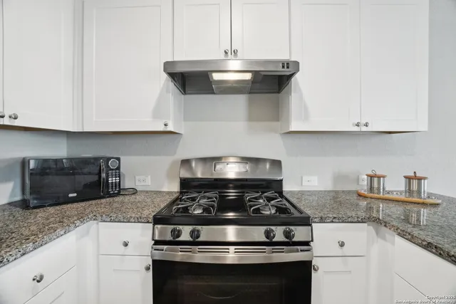 a stove top oven sitting inside of a kitchen