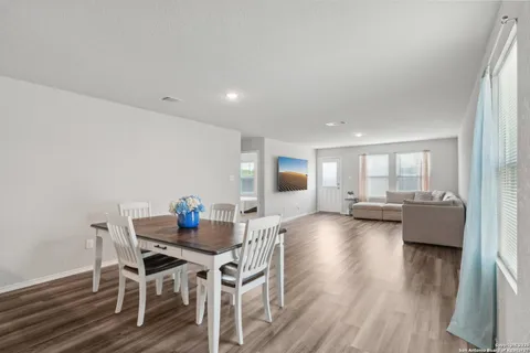 a living room with fireplace furniture and a wooden floor
