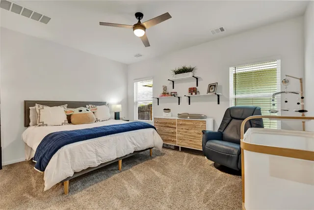 a bedroom with a bed couch and window