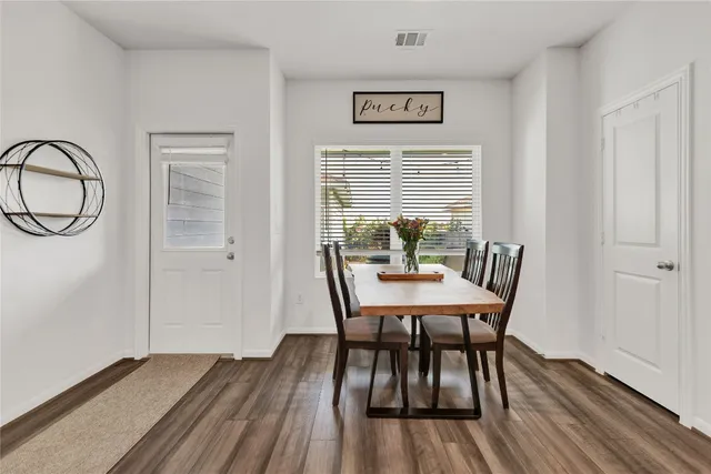 a view of a room with a table and chairs