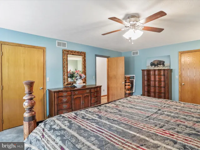 a bedroom with a bed and a cabinet