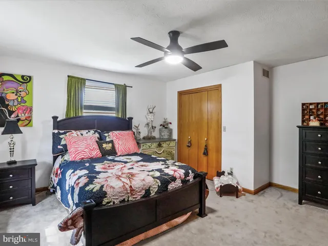 a bedroom with a bed and a dresser