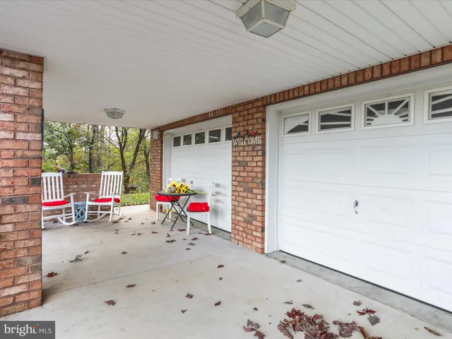 a view of a patio with a table and chairs and potted plants