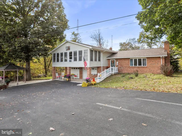 a view of a house with a yard and sitting area
