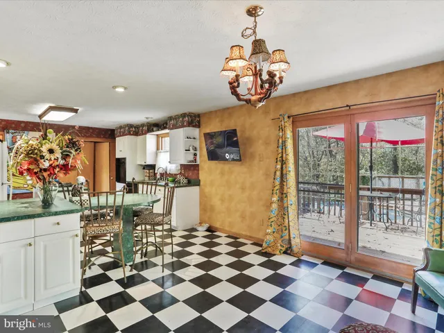 a room with lots of white furniture and natural light
