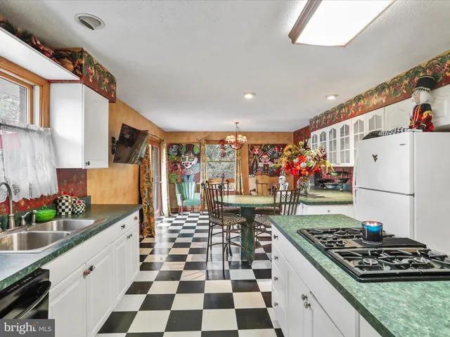 a kitchen with stainless steel appliances granite countertop a stove and a sink