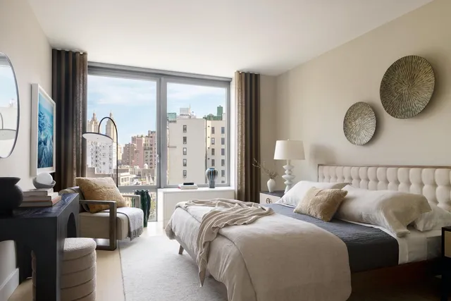 a bedroom with bed and a large window