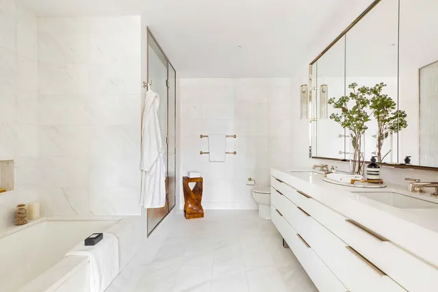 a bathroom with a tub sink and mirror