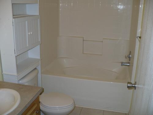 1283 Potter Road Tieton, WA 98947 - Photo 5 of 8 a white toilet and tub sitting next to a shower