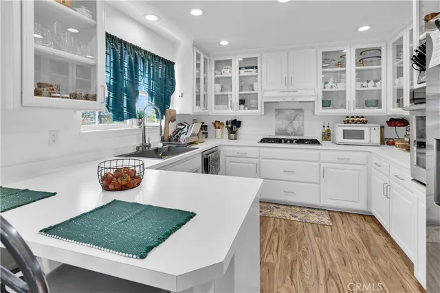 a kitchen with stainless steel appliances granite countertop a sink stove and cabinets