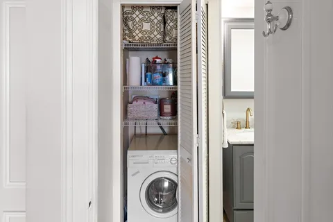 a view of a hallway with a washer and dryer