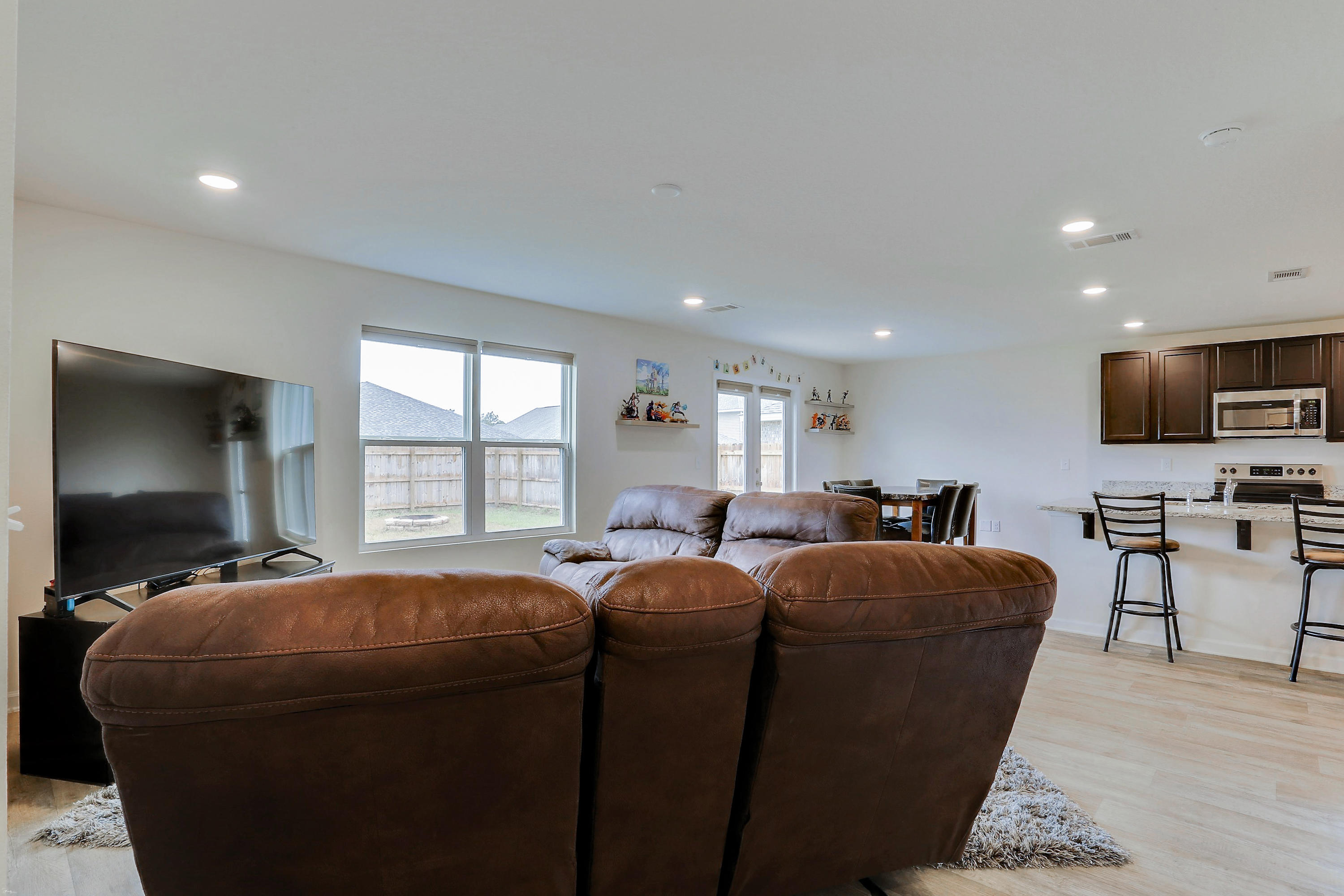 931 Merganser Way Crestview, FL 32539 - Photo 18 of 39 a living room with furniture a flat screen tv and large window