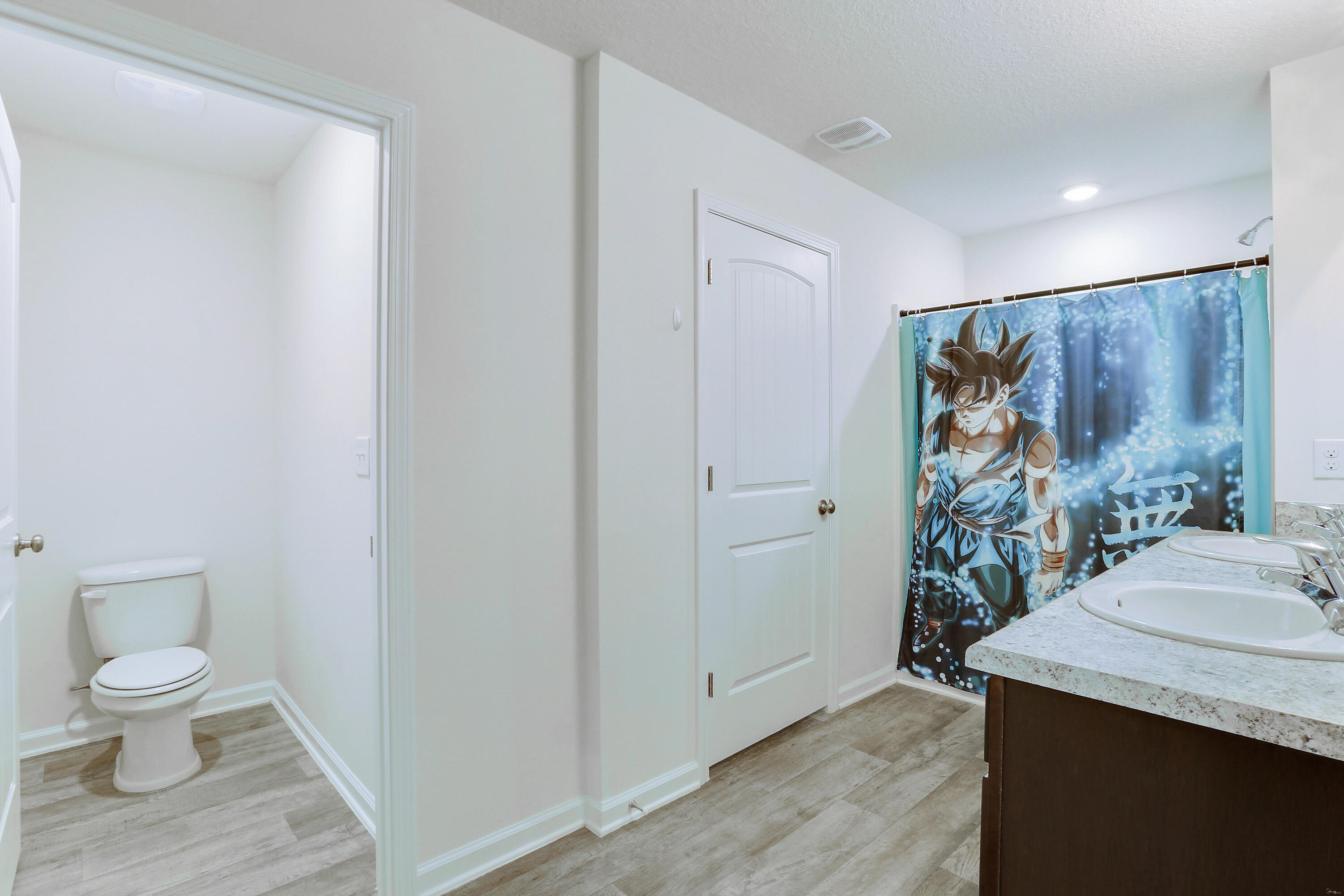 931 Merganser Way Crestview, FL 32539 - Photo 27 of 39 a bathroom with a granite countertop sink a toilet and a shower