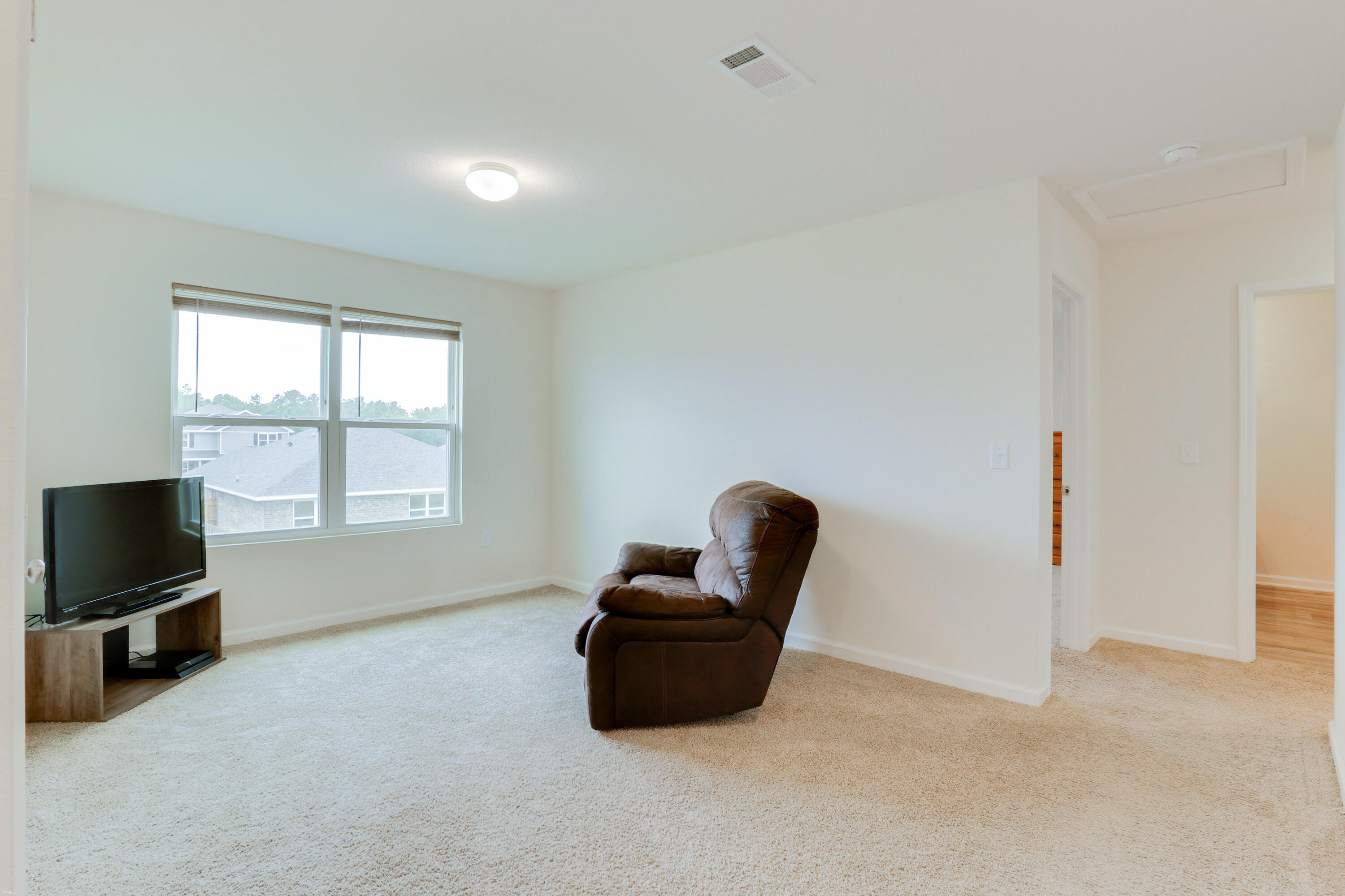 931 Merganser Way Crestview, FL 32539 - Photo 30 of 39 a living room with furniture and a flat screen tv