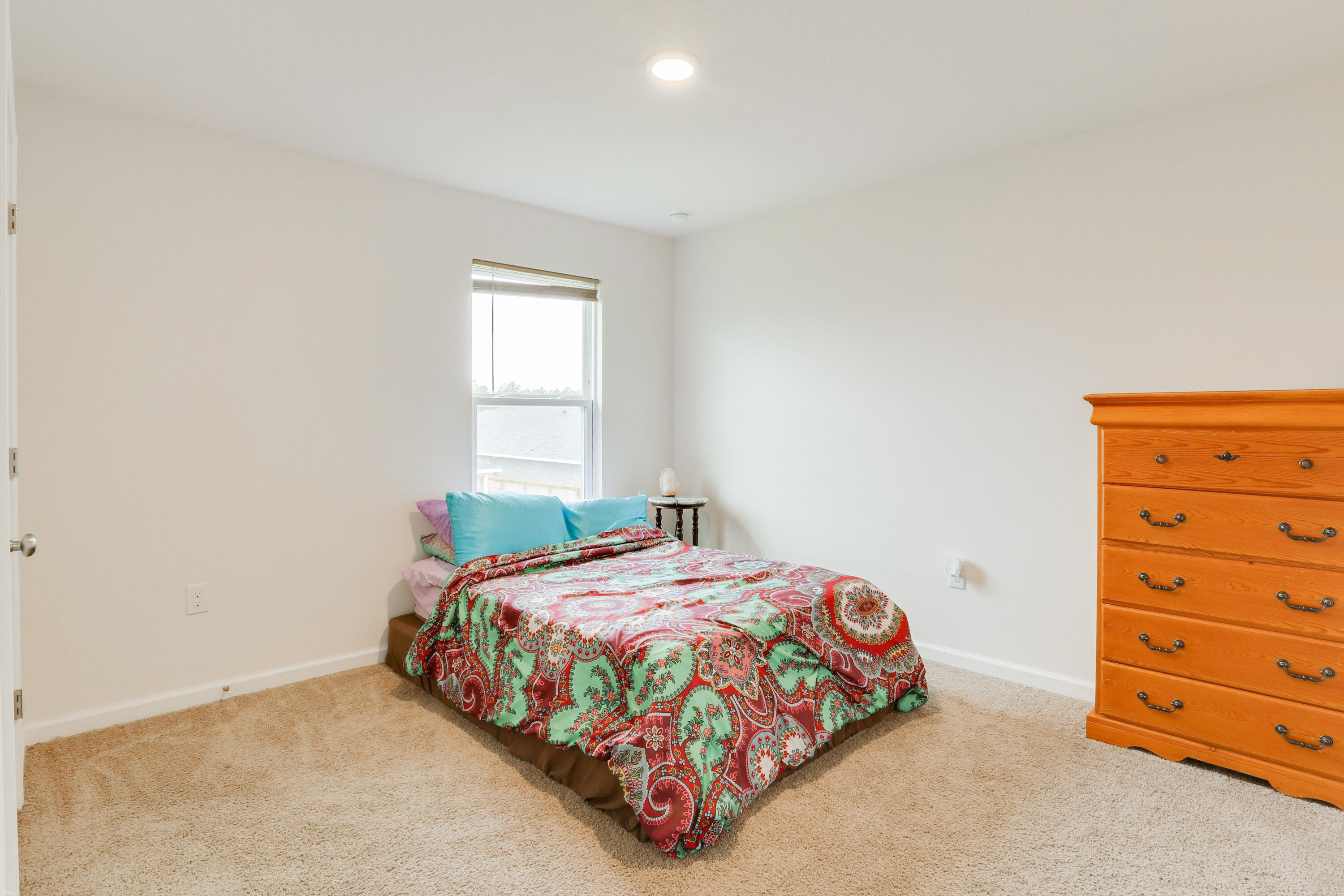 931 Merganser Way Crestview, FL 32539 - Photo 32 of 39 a bedroom with a bed and a dresser