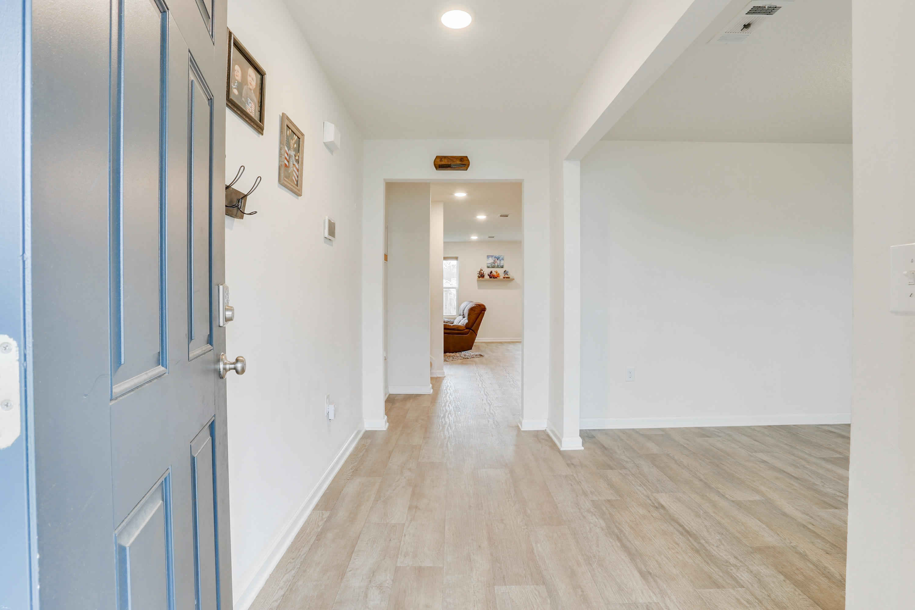 931 Merganser Way Crestview, FL 32539 - Photo 5 of 39 a view of a hallway with wooden floor and a living room