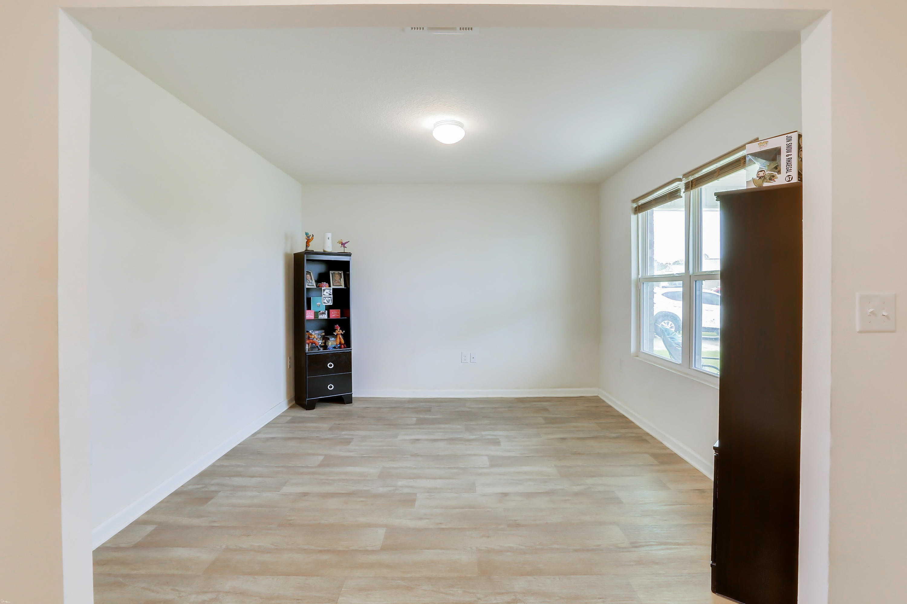 931 Merganser Way Crestview, FL 32539 - Photo 7 of 39 wooden floor in an empty room with a window