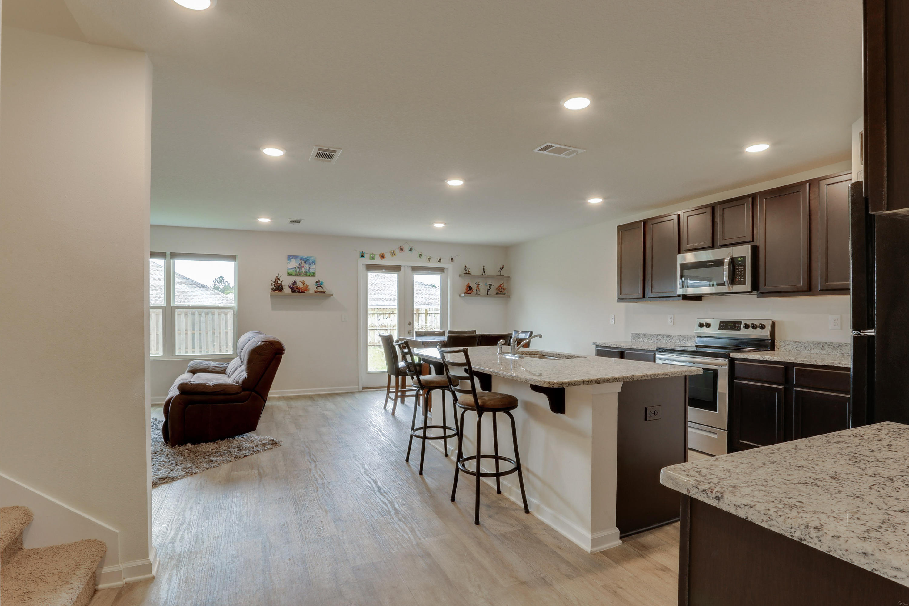 931 Merganser Way Crestview, FL 32539 - Photo 10 of 39 a kitchen with cabinets and wooden floor