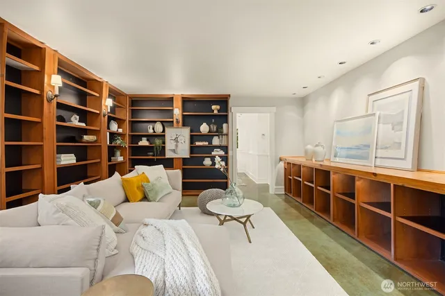 a living room with furniture and a book shelf
