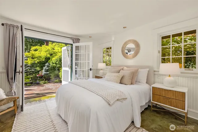 a bed room with a bed and a large window