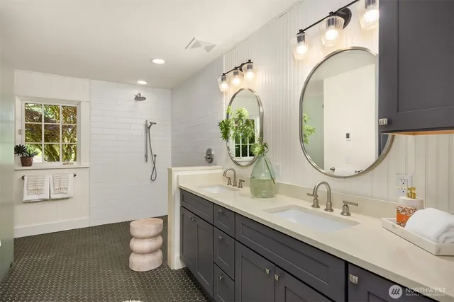 a bathroom with 2 sink and a mirror