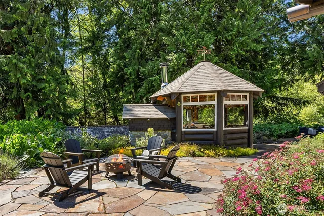 a view of patio with a table and chairs under an umbrella