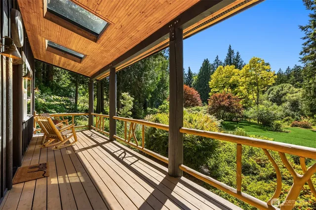 a view of balcony with chairs and wooden floor