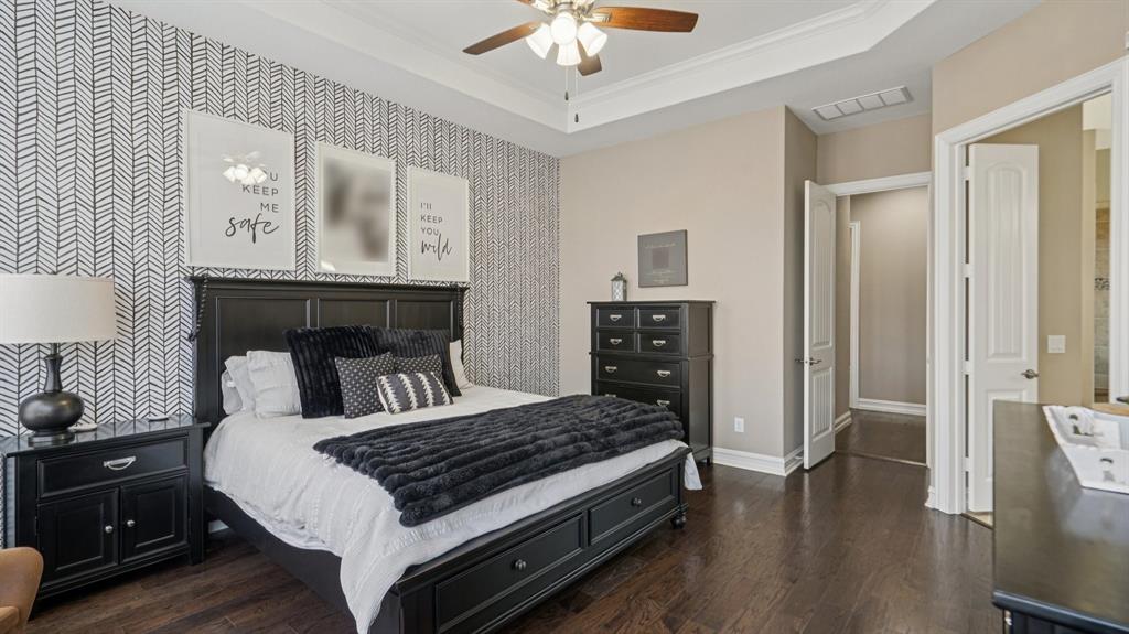 11192 Progreso Street Frisco, TX 75035 - Photo 15 of 30 a bedroom with a bed and a chandelier