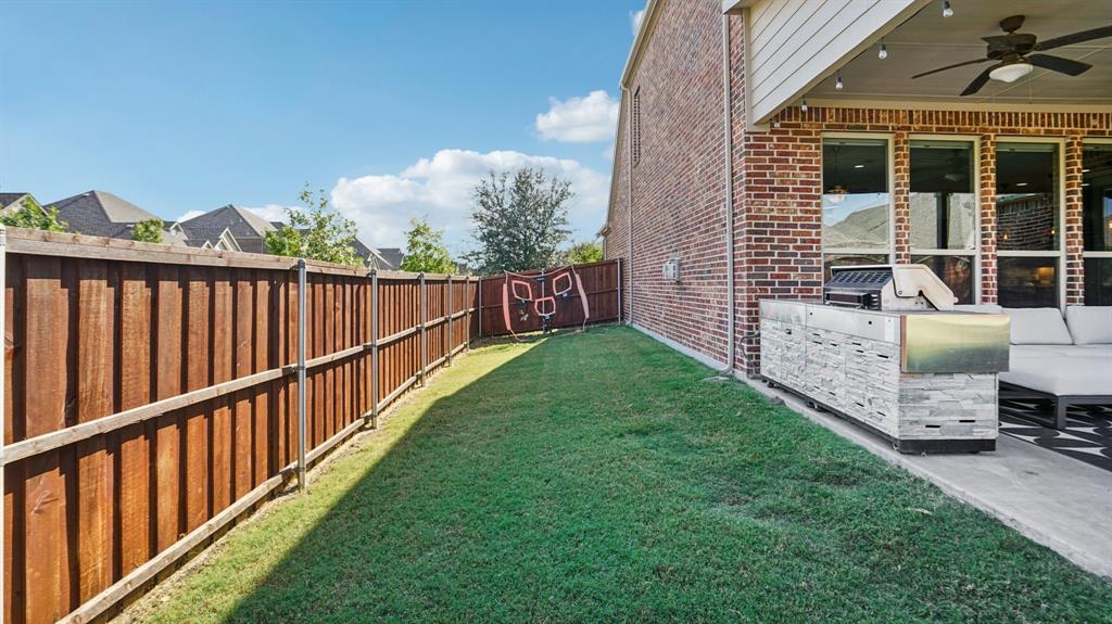 11192 Progreso Street Frisco, TX 75035 - Photo 28 of 30 a view of a chair and table in the back yard of the house