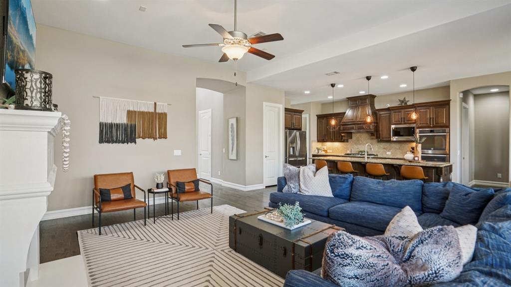 11192 Progreso Street Frisco, TX 75035 - Photo 6 of 30 a living room with furniture kitchen view and a chandelier