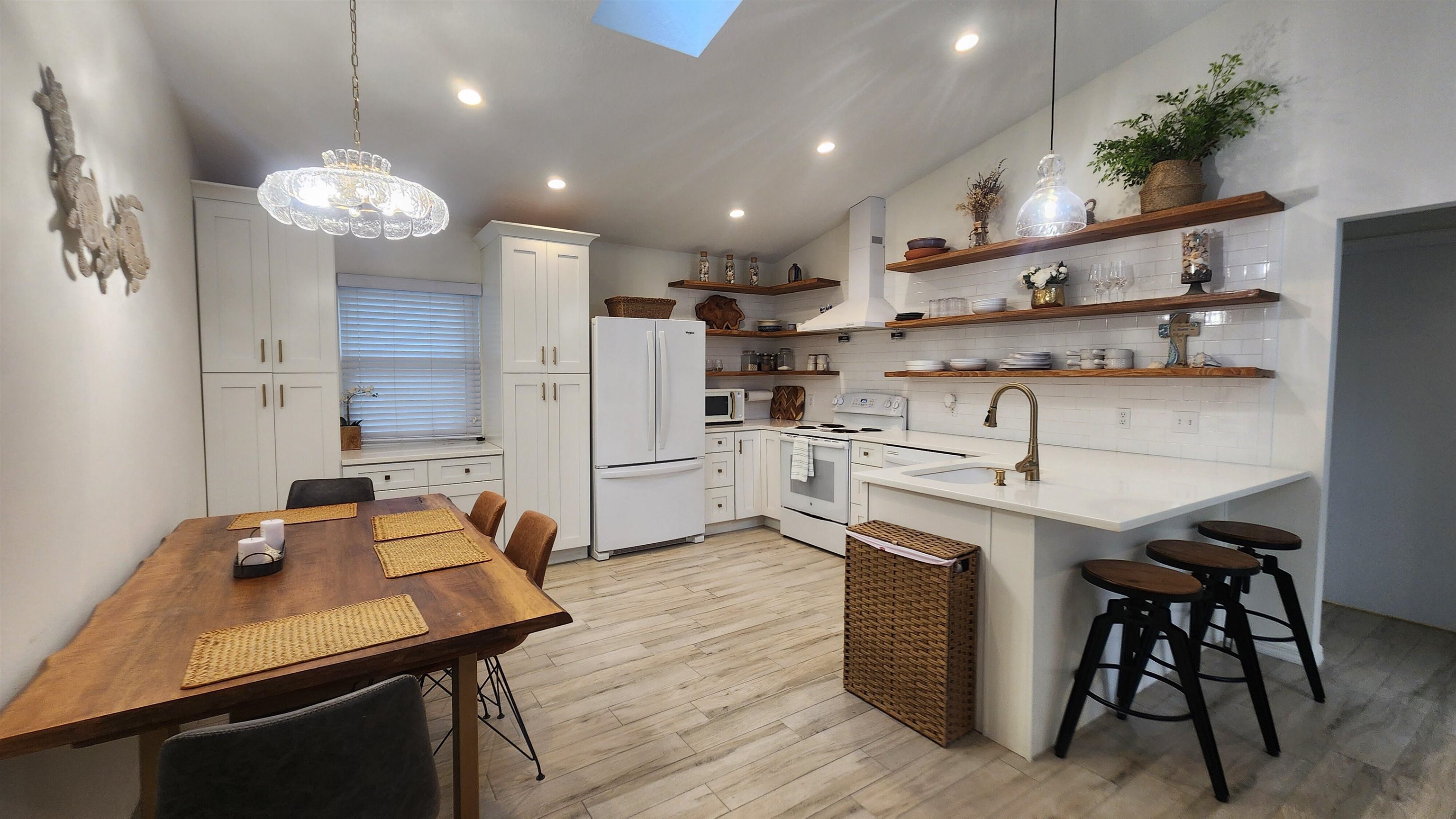 206 4th Street St. Augustine, FL 32080 - Photo 3 of 11 a kitchen with kitchen island a sink appliances and a counter top