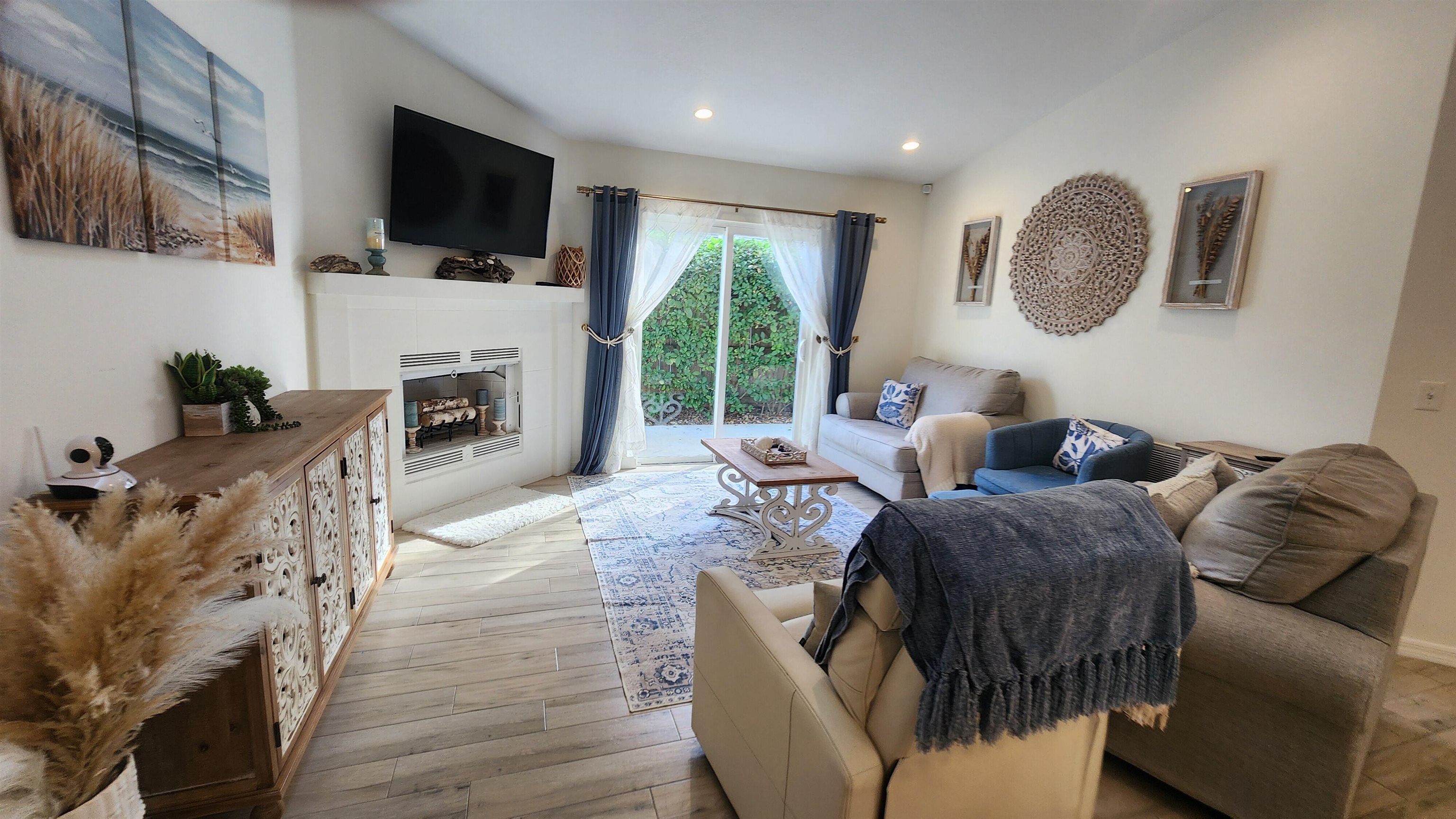 206 4th Street St. Augustine, FL 32080 - Photo 5 of 11 a living room with furniture a flat screen tv and a fireplace