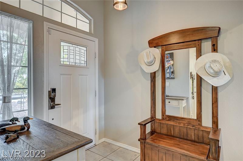 987 Cutter Street Henderson, NV 89011 - Photo 17 of 17 A welcoming entry features a door with decorative glass, complemented by ceramic tile flooring.
