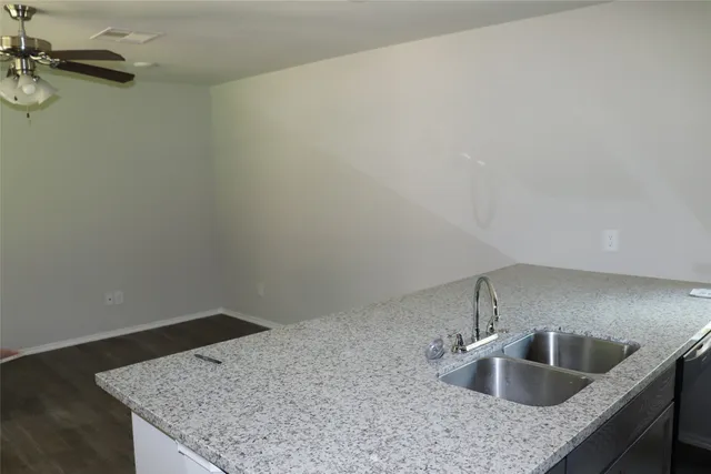 a kitchen with a sink and cabinets