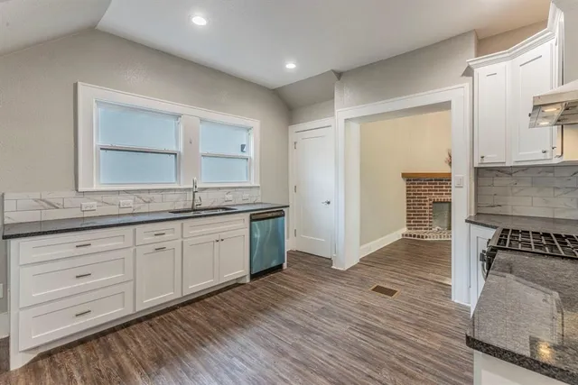 a spacious bathroom with a granite countertop sink and a mirror