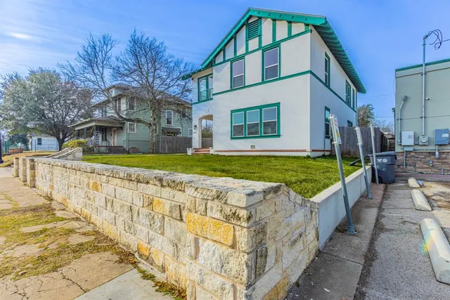 a view of a house with swimming pool in front of it