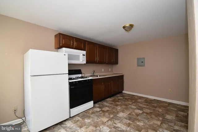 a kitchen with a refrigerator and a stove