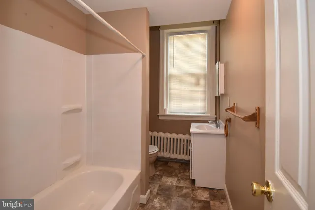 a bath room with a bath tub and a shower