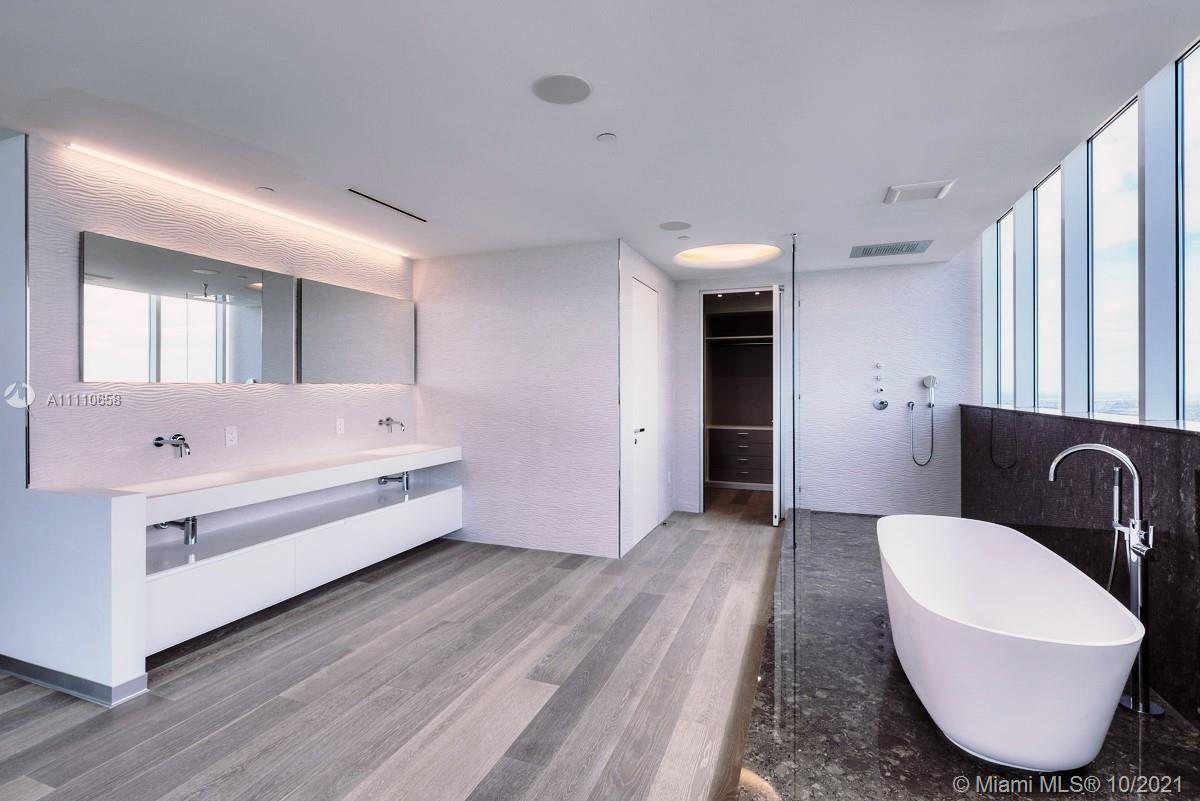 Edgewater Miami, FL 33137 - Photo 20 of 42 a bathroom with a tub sink and mirror