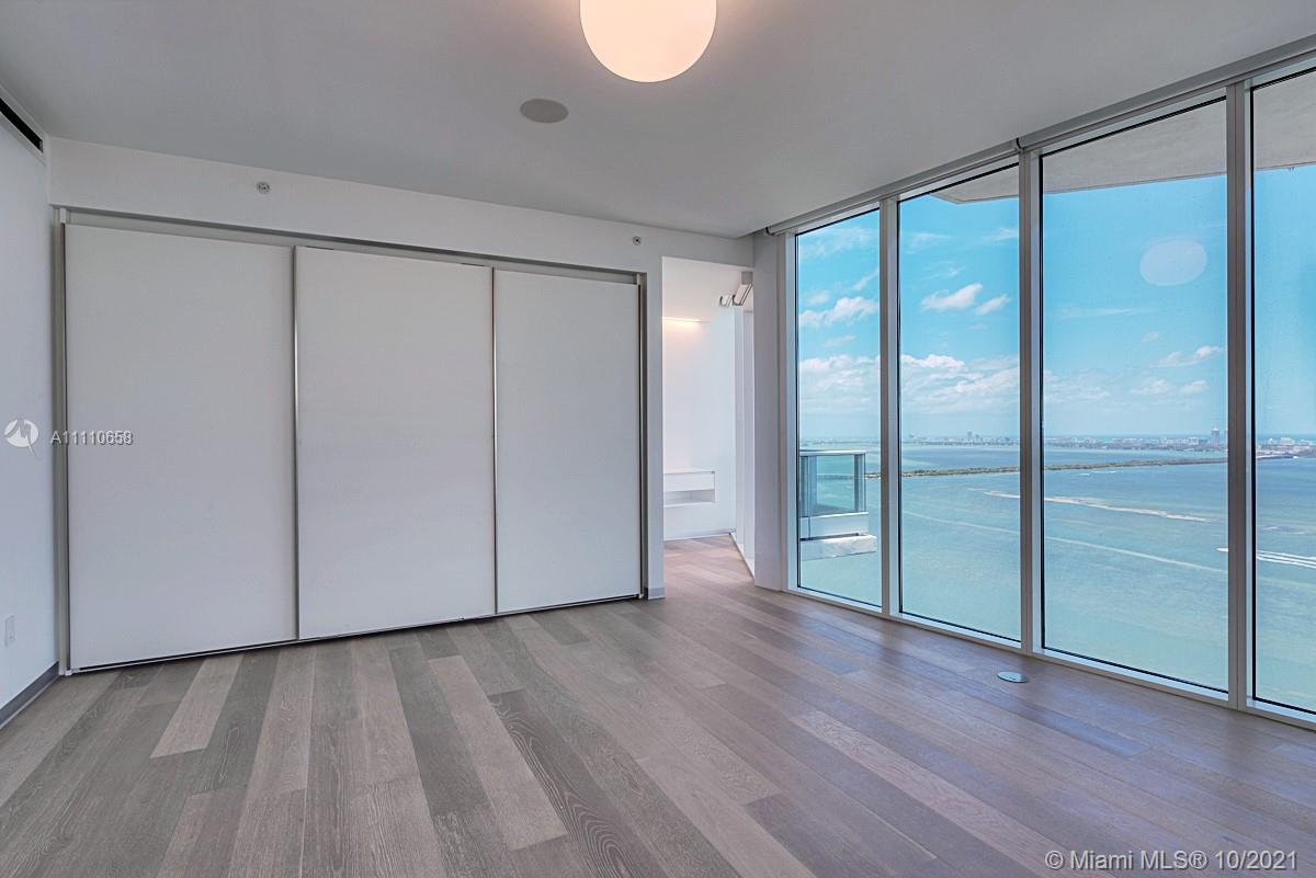 Edgewater Miami, FL 33137 - Photo 24 of 42 a view of an empty room with wooden floor and a window