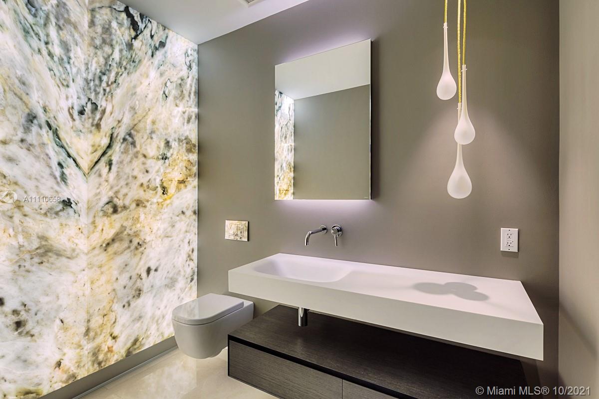 Edgewater Miami, FL 33137 - Photo 34 of 42 a bathroom with a sink and a mirror