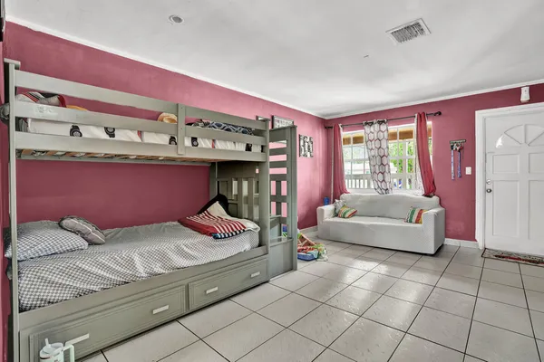 a kitchen with stainless steel appliances a stove a refrigerator and a dining table