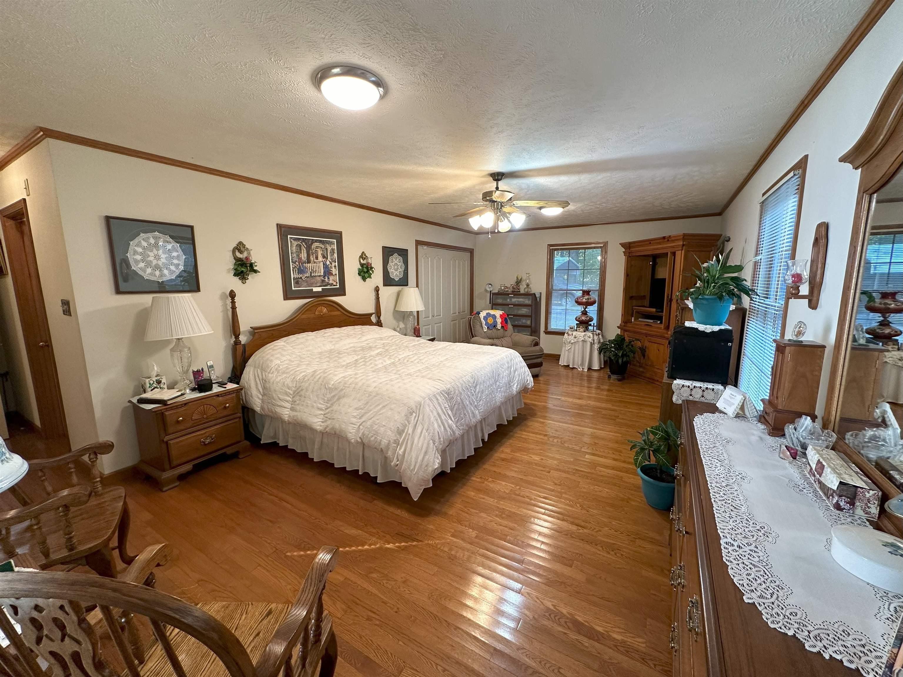 883 Crucifer Road Huron, TN 38345 - Photo 11 of 22 Bedroom with ceiling fan, crown molding, a textured ceiling, and light wood-type flooring
