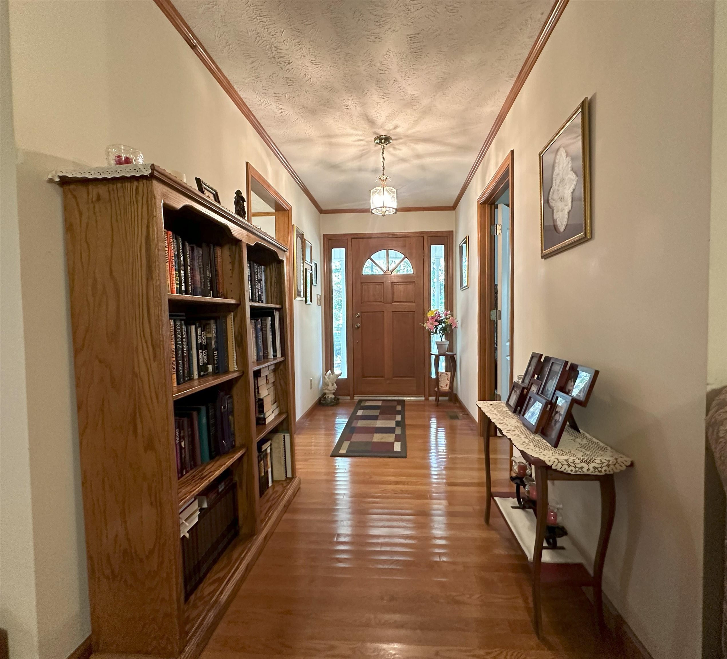 883 Crucifer Road Huron, TN 38345 - Photo 14 of 22 Foyer entrance featuring ornamental molding, a textured ceiling, and dark wood-type flooring